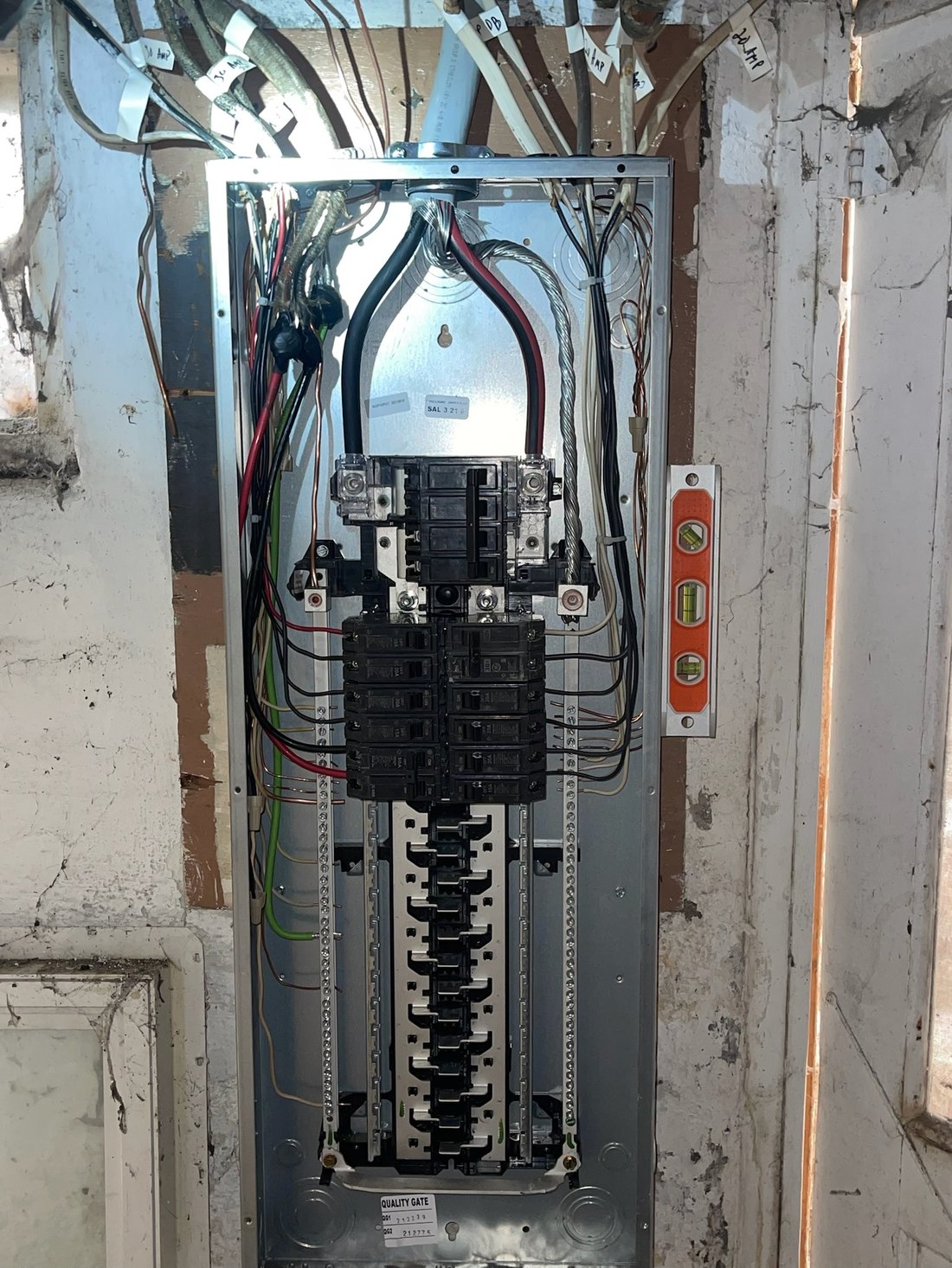 A newly installed 200-amp residential load center with conductors dressed and every circuit labeled